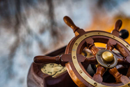 Wooden steering wheel on an old shipの写真素材