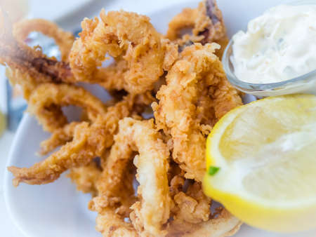Deep fried calamari served with lemon and mayoの写真素材