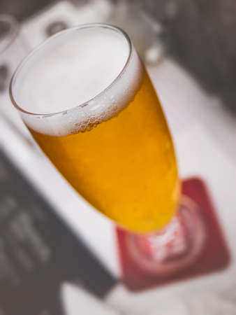 Glass of beer on a table in a restaurantの写真素材