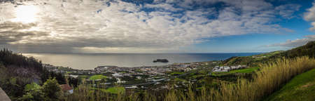 View of the small Ilheu island as seen from the courtyard of the Our Lady of Peace chapel in Franca do Campo in Sao Miguel Island in the Azores.の写真素材