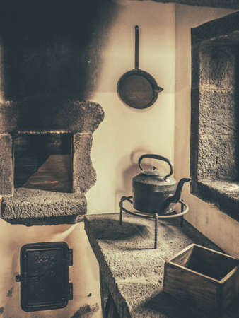 Old black kettle in an old kitchen in a traditional tearoom in an old tea factory in a small village on the coast of Sao Miguel, Azores, Portugalの写真素材
