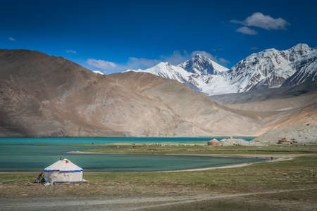 Kirgiz yurt on the shore of the Kara Kul lake in Karakorum, Chinaの写真素材