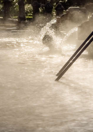 Man having bath in the Ferruginous hot water spring pool in furnas, Sao Miguel Island, Azores, Portugalの写真素材