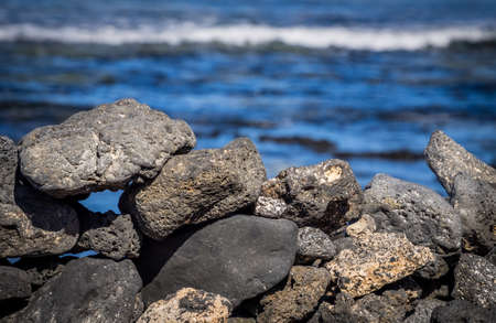 Black volcanic rocks on the coast in Corralejo, Fuerteventura, Canary Island, Spainの写真素材