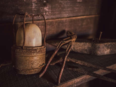 Old rusted lamp and tools in a shed in a villageの写真素材