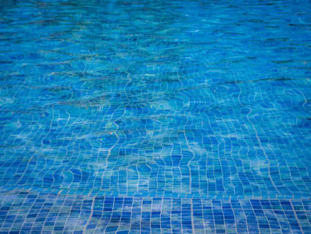 Water in the swimming pool with squared pattern floor tilesの写真素材