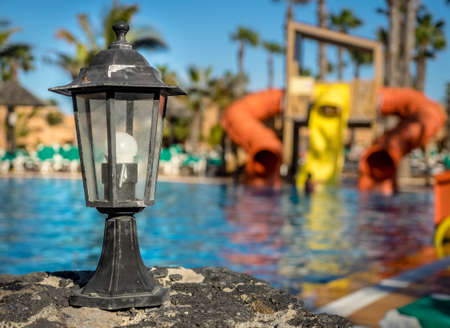 Old rustic lamp standing next to the swimming poolのeditorial素材