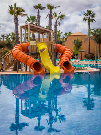 Slides for children at a large swimming pool in a resort in Fuerteventura, Canary Islands, Spain....