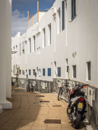 Motorbike and bicycles parked in a narrow street in Playa Blanca, Lanzarote, Canary Islands, Spain....