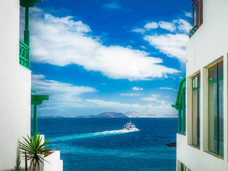 View of the ocean from the window of traditional house in Playa Blanca, Lanzarote, Canary Islands,...