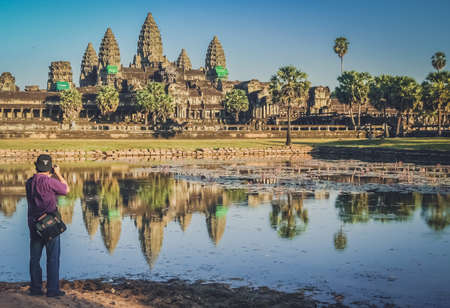 Angkor Wat, Cambodia -  August 2007: Tourist taking picture of the Angkor Wat temple, Cambodia
