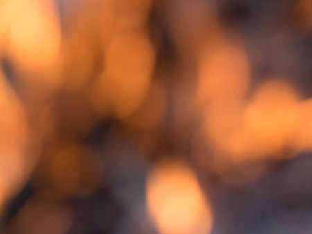 Defocused fire flames bokeh warm orange background