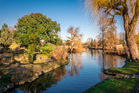 Panoramic picture of a small lake and public footpath  in Regents Park, Londonの写真素材