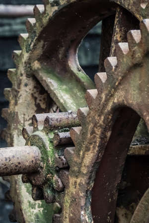 Closeup detail of the old rusting disused winches for drawing fishing boats onto beach at Hasting in East Sussex, Englandの写真素材