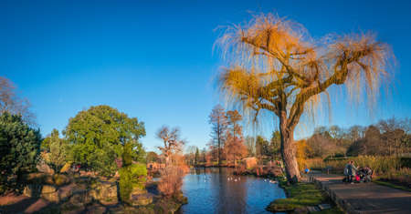 London, England - December 29, 2016: Panoramic picture of a small lake and public footpath  in...