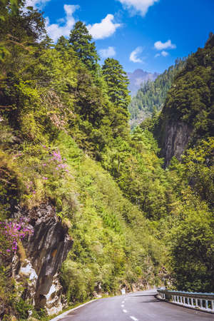 Road through the beautiful mountain valley on the borders of Tibet and Yunnan province, Chinaの写真素材
