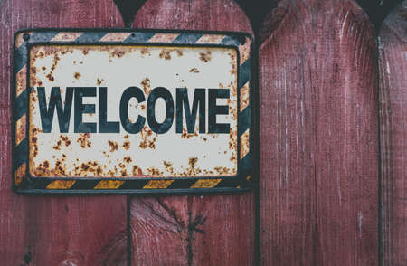 Welcome plaque on a grunge wooden fenceの写真素材