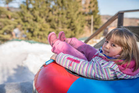 Little girl ready to slide downhillの写真素材