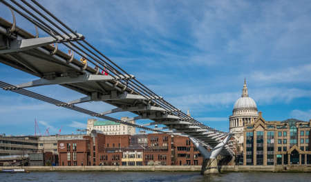 London, England -  25 March 2017 : London Millennium Footbridge across Thames river with St Pauls Cathedral in the background, Englandのeditorial素材