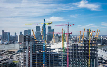 London, England -  25 March 2017 : Colorful cranes at work at London building site near the O2 Arena in Greenwich, England, UKのeditorial素材