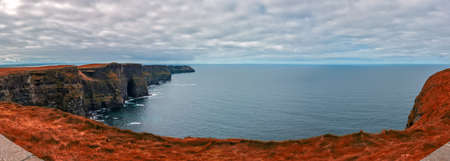 Panoramic view over Cliffs of Moher on a overcast, cloudy and gloomy day, Irelandの写真素材