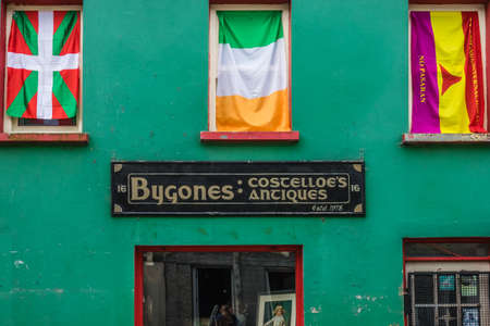 Limerick, Ireland -  April 2017 : Irish and two other flags in windows above an old antiques shop in Limerick, Irelandのeditorial素材