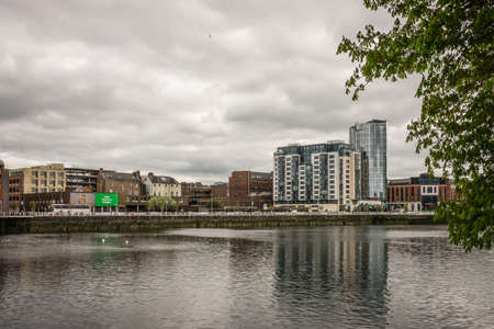 Limerick, Ireland -  April 2017 : View of the Shannon river, hotels, commercial and residential buildings in Limerick, Irelandのeditorial素材