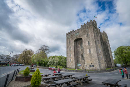 Bunratty castle, Ireland -  April 2017 : Tourists in front of the Bunratty castle on a cloudy day, county Clare, Irelandのeditorial素材