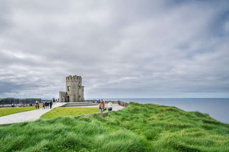 Cliffs of Moher, Ireland -  April 2017 : Tourists at the O Briens Tower at the Cliffs of Moher, Irelandのeditorial素材