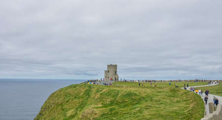 Cliffs of Moher, Ireland -  April 2017 : Tourists at the O Briens Tower at the Cliffs of Moher, Irelandのeditorial素材