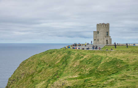 Cliffs of Moher, Ireland -  April 2017 : Tourists at the O Briens Tower at the Cliffs of Moher, Irelandのeditorial素材