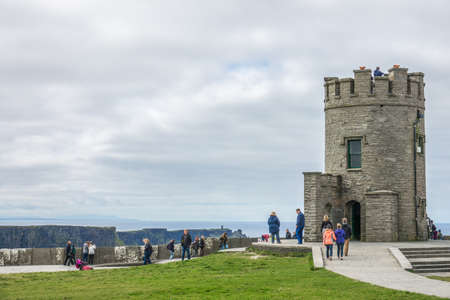 Cliffs of Moher, Ireland -  April 2017 : Tourists at the O Briens Tower at the Cliffs of Moher, Irelandのeditorial素材