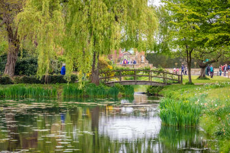 Hever Castle, England -  April 2017 : Small wooden bridge in the Hever castle gardens, Kent, England, UKのeditorial素材