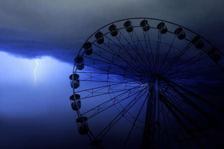 Funfair wheel in on a stormy dayの写真素材