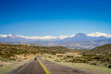Woman cycling on the famous national Ruta 40 quarenta in central Argentinaの写真素材
