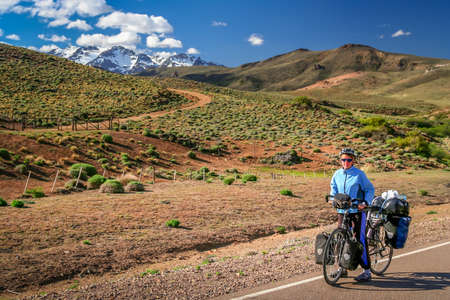 Woman cycling on the famous national Ruta 40 quarenta in central Argentinaの写真素材