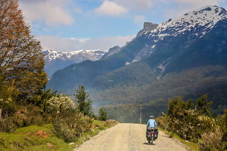 Cyclist climbing up the hill on the Carretera Austral, southern Patagonia, Chileの写真素材