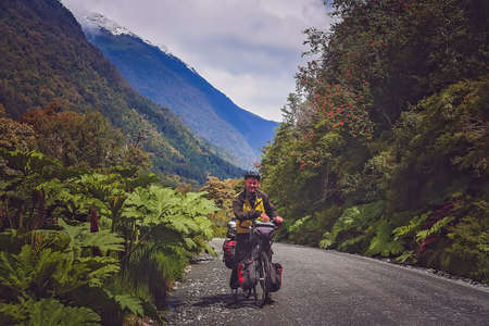 Cyclist on a cycle touring round the world trip pausing for a photo on the Carretera Austral, southern Patagonia, Chileの写真素材