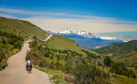 Cyclist climbing up the hill on the Carretera Austral, southern Patagonia, Chileの写真素材