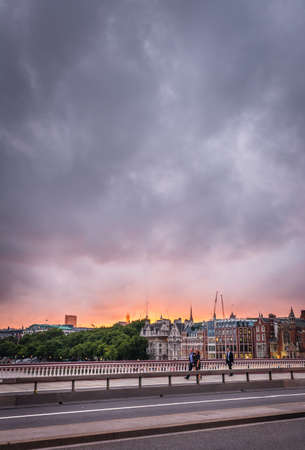 London, England - July 26, 2017 :  Commuters walking on the Blackfrairs bridge at dusk, Londonのeditorial素材