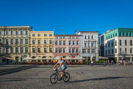 Bydgoszcz, Poland -  August 2017 : Man cycling on his mtb through the Old Town squareのeditorial素材