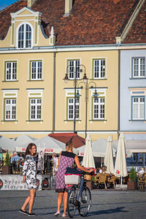 Bydgoszcz, Poland -  August 2017 : Two woman walking in the Old Town square in Bydgoszcz, Polandのeditorial素材