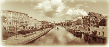 Bydgoszcz, Poland -  August 2017 : Sepia vintage panorama of Bydgoszcz with the tightrope walker sculpture over the River Brdaのeditorial素材