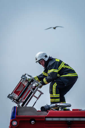 Sarbinowo, Poland - August 2017 : Firefighter unloading equipment from his truck to pump out excess...