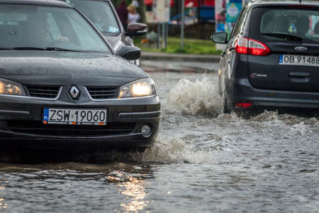 Sarbinowo, Poland -  August 2017 : Cars going through the flooded street after extremely heavy rainfallのeditorial素材