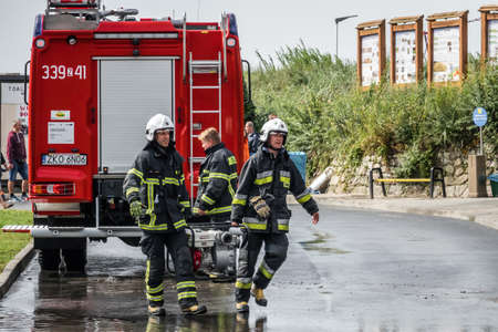 Sarbinowo, Poland -  August 2017 : Firefighters preparing for a job to pump out excess water from flooded road after heavy torrential rainのeditorial素材
