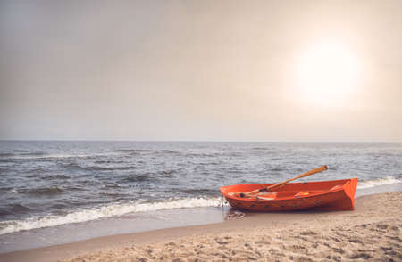 Orange lifeguard rescue boat on the beach in summerの写真素材