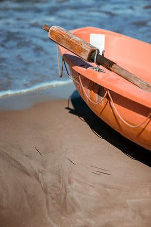 Orange lifeguard rescue boat on the beach in summerの写真素材