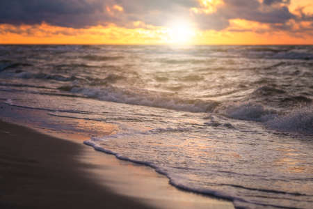 Sunset over the sea beach in summer with shallow depth of field