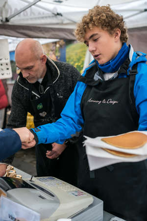 Bergen, Norway -  October 2017 :  Men selling delicious pancakes on the street food marketのeditorial素材